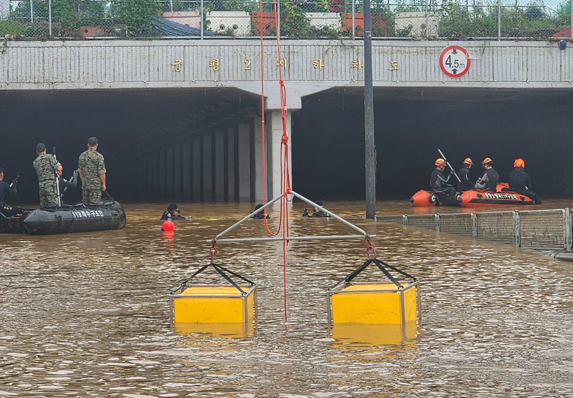 Firefighters and rescue workers look for survivors in an underpass in Cheongju, South Korea, on July 16, 2023.