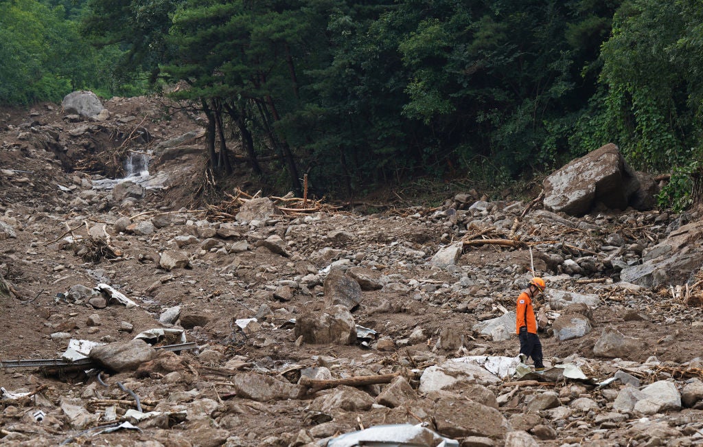 A South Korean rescue worker searching for missing persons after a landslide hit a village following heavy rains on July 16, 2023 in Yecheon, South Korea. 