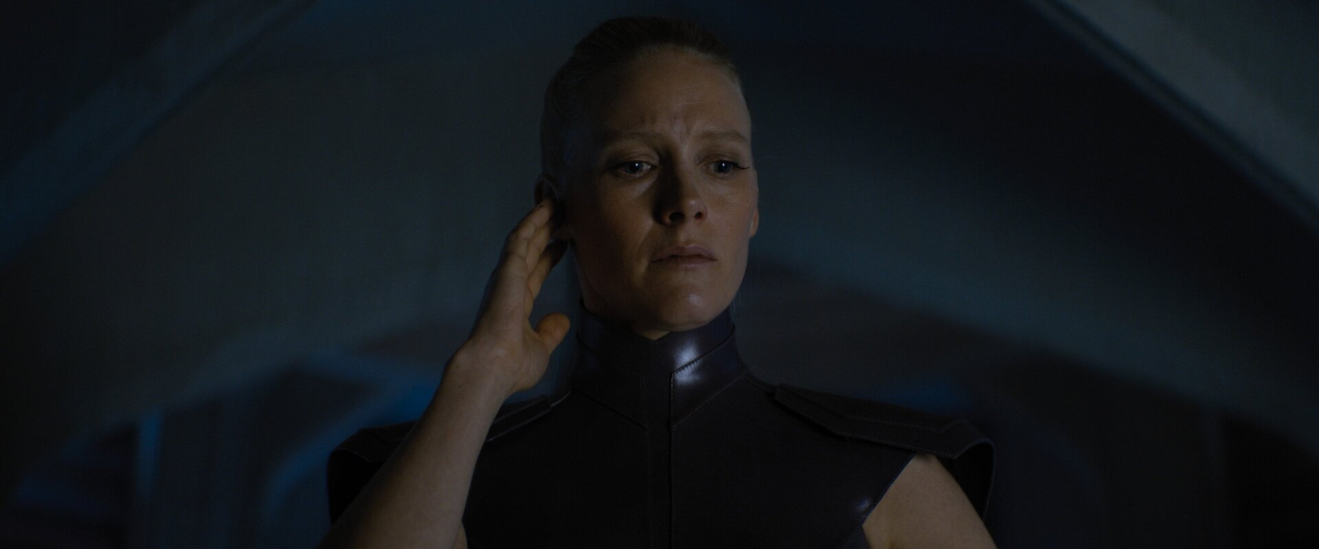 The puppetmaster, who is also a puppet herself.