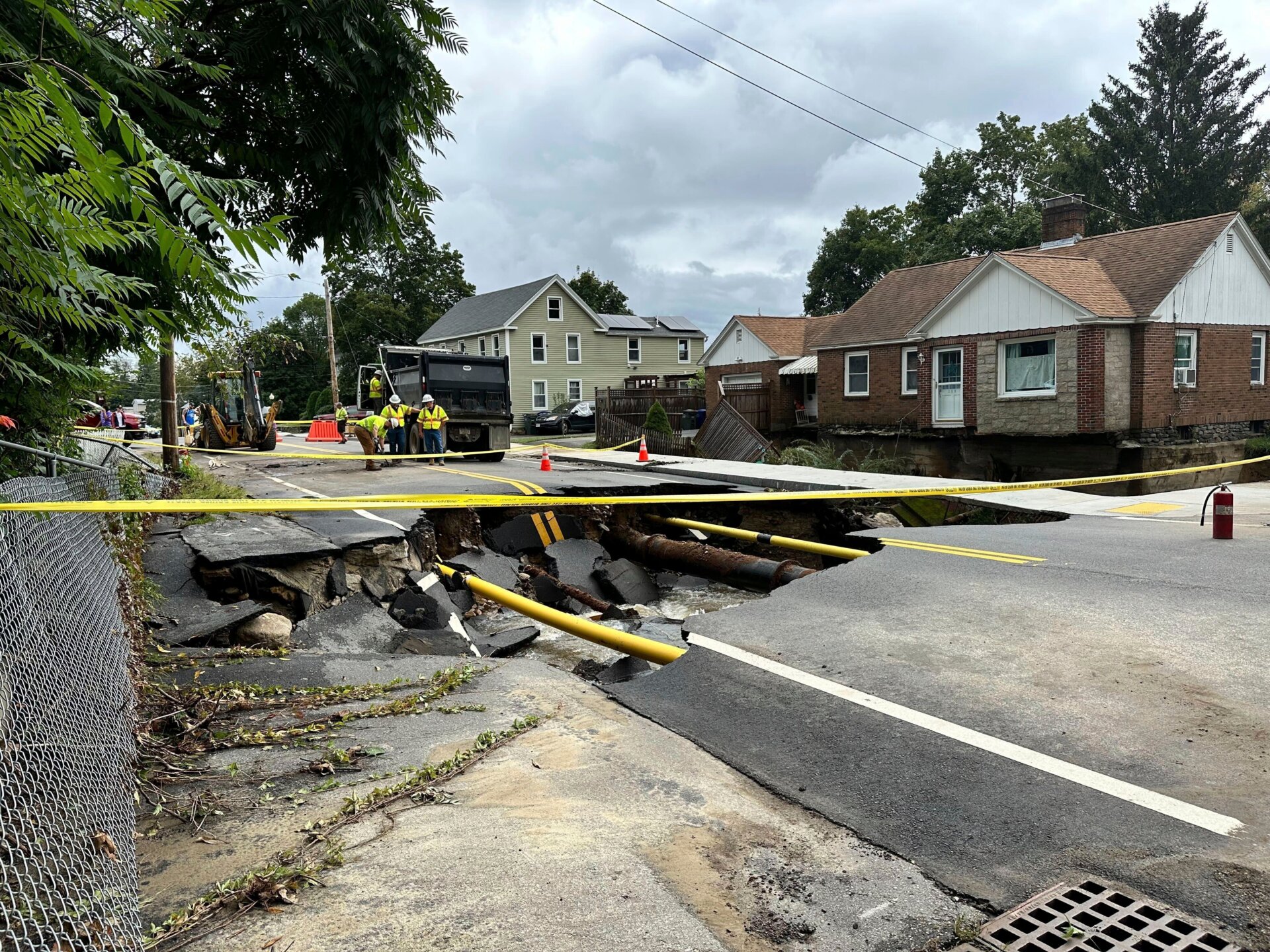 Road crews assess a sinkhole on Chestnut Street in Leominster, Massachusetts, on September 12, 2023.