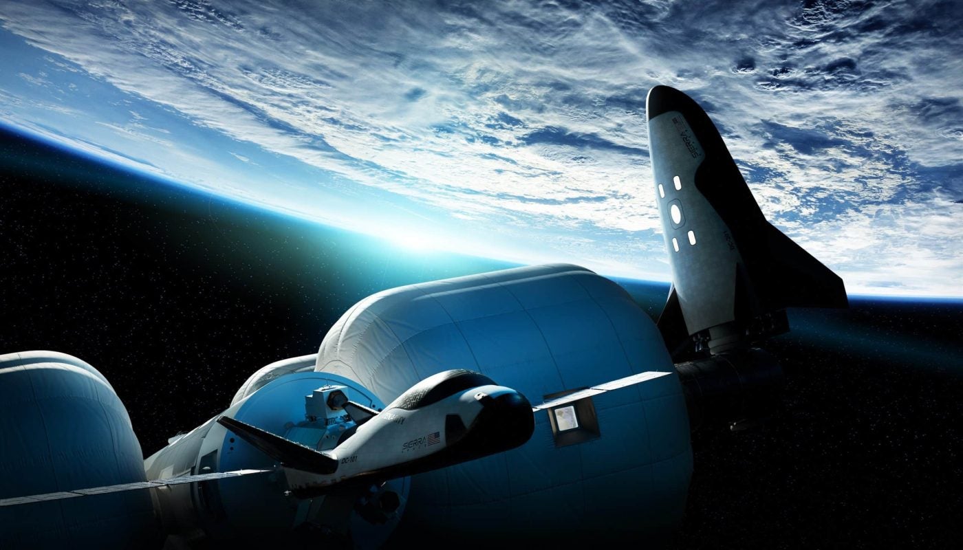 Artistic conception of Dream Chaser working in low Earth orbit.