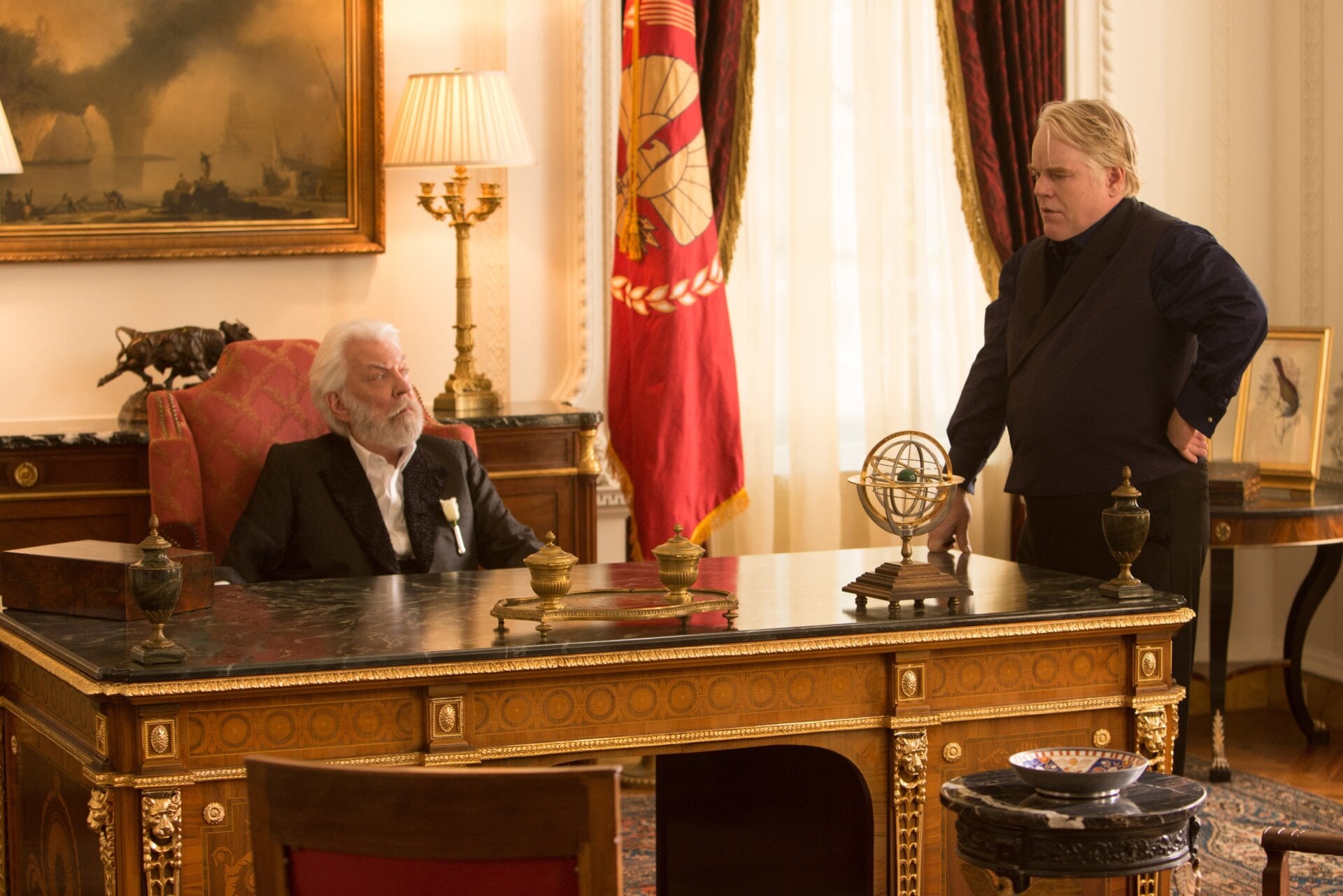Donald Sutherland (President Snow) and Philip Seymour Hoffman (Plutarch Heavensbee) in The Hunger Games: Catching Fire.