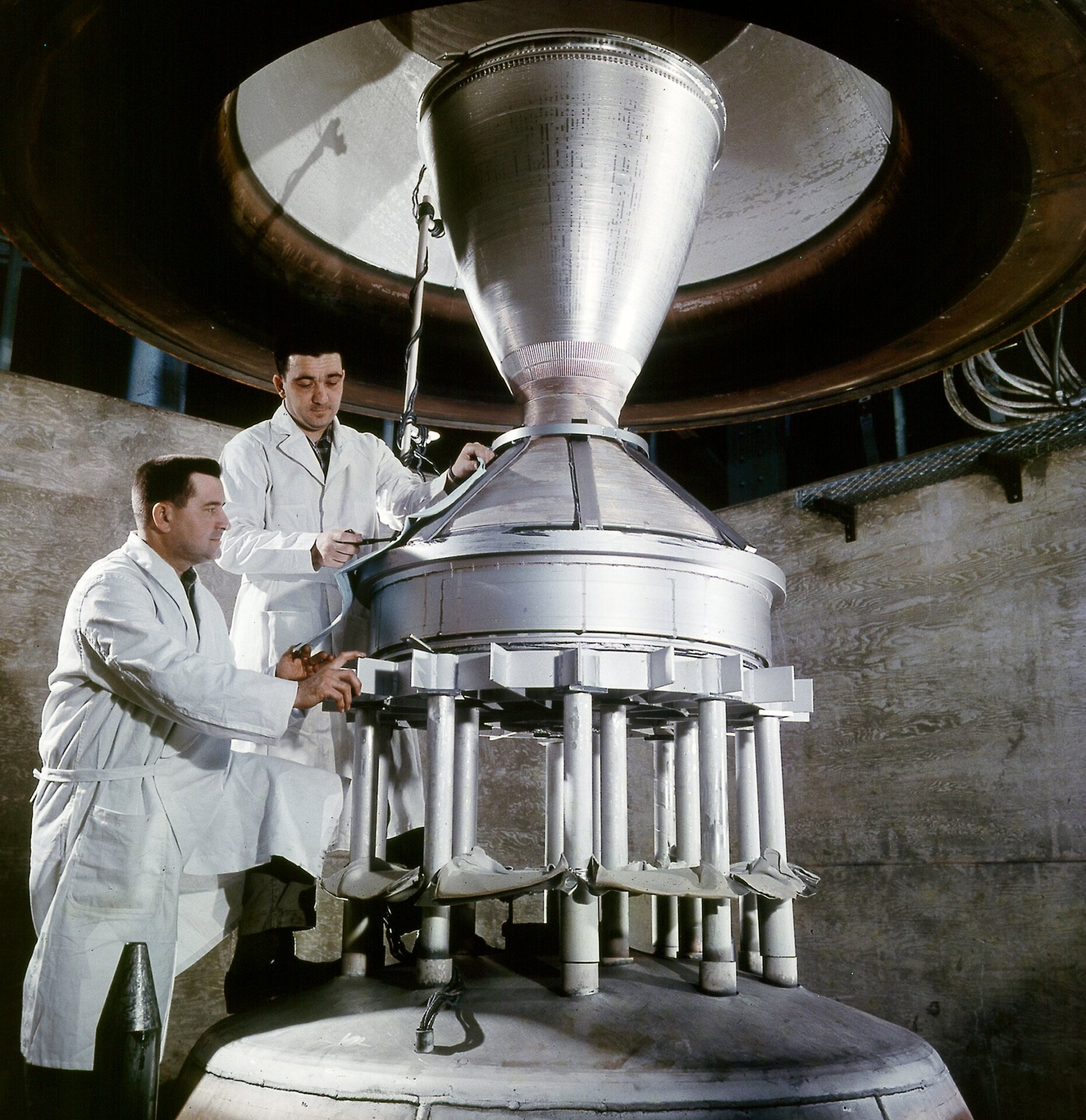 Technicians at work on a conceptual nuclear rocket in 1964.