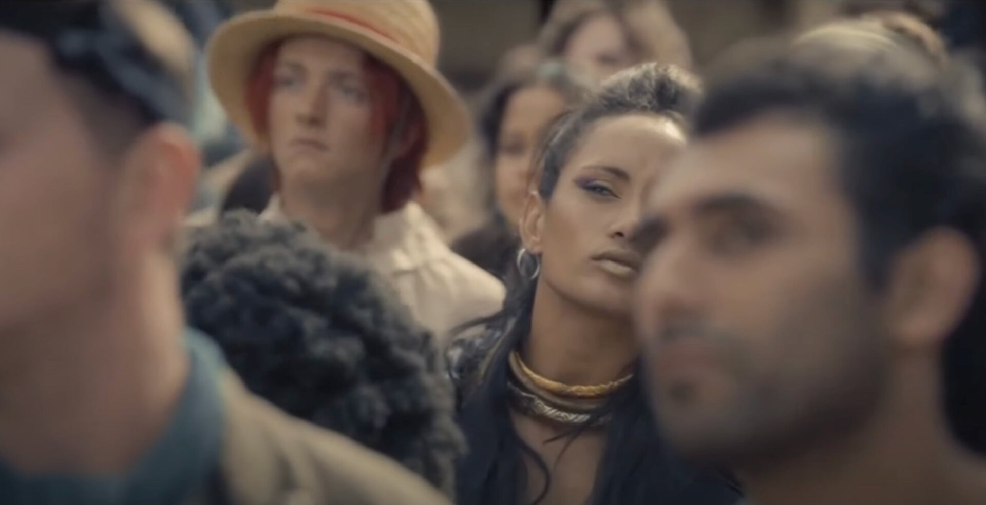 The woman who might be future pirate Crocodile with a young Shanks in the back