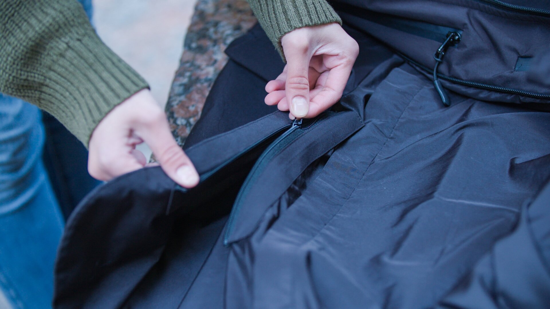 Unzipping the snow skirt.