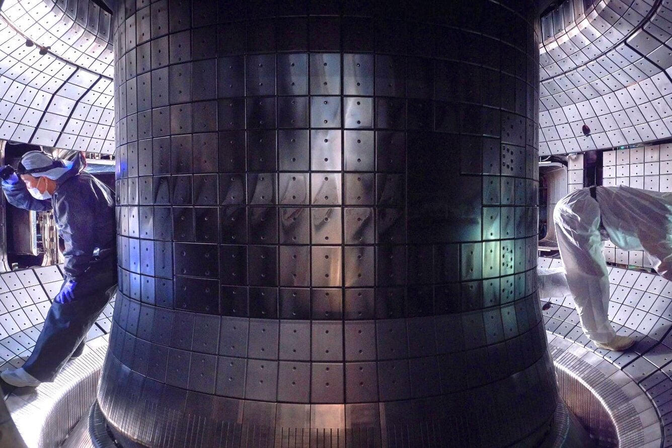 Workers inside the vacuum vessel of the KSTAR tokamak reactor in South Korea.