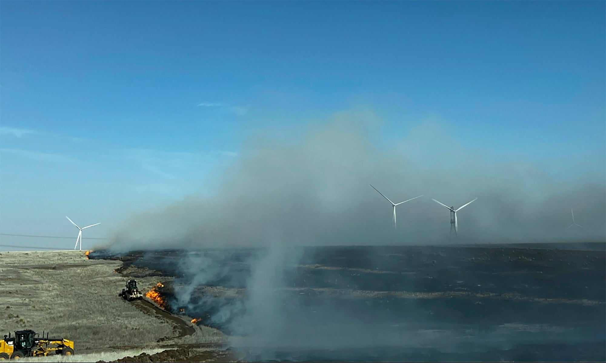 In this image provided by Texas A&M Forest Service, heavy equipment  works to contain the Juliet Pass Fire in Armstrong County, Texas, on  Monday, Feb. 26, 2024.