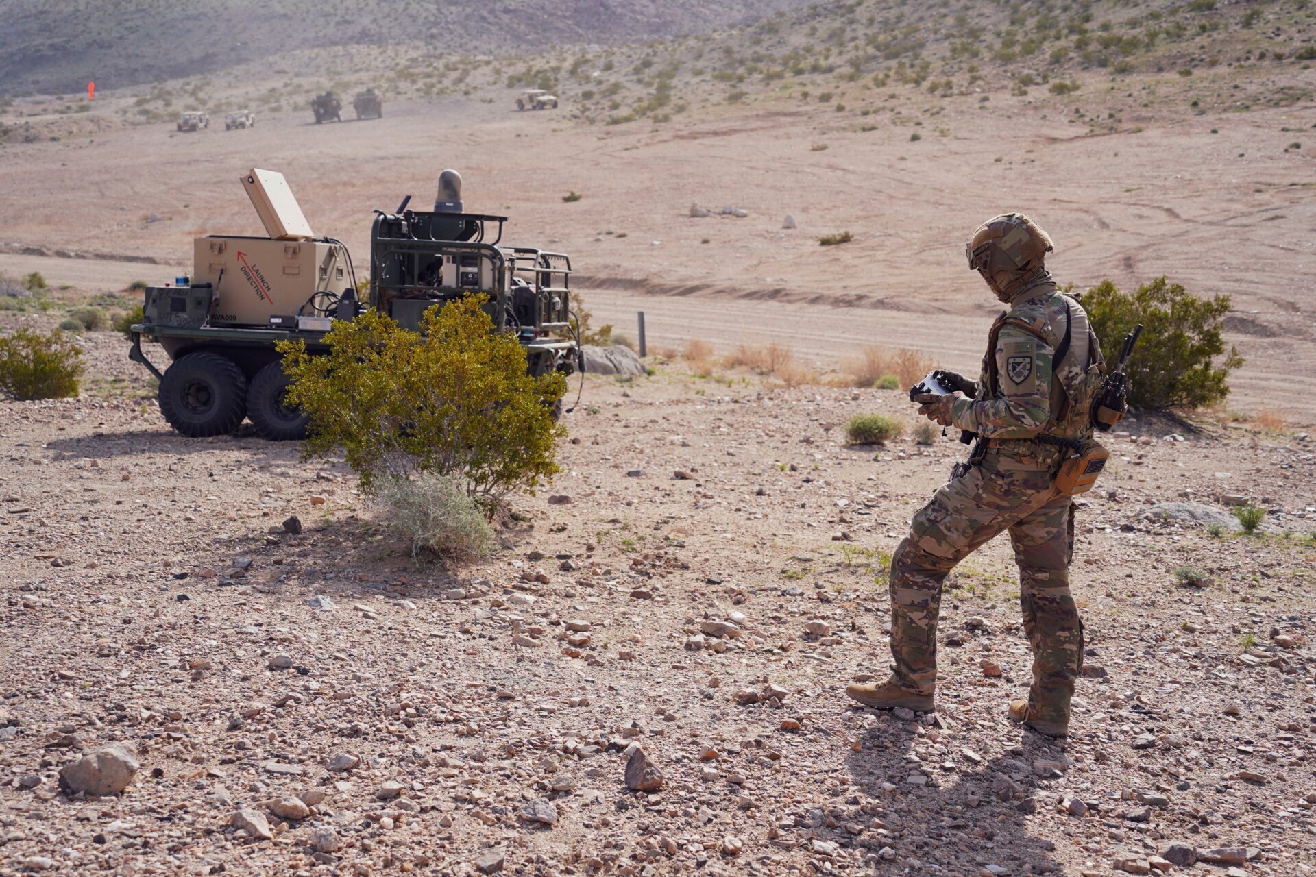 U.S. Army Pfc. Darren Campbell, infantryman assigned to the Alpha  Company, 1st Battalion, 29th Infantry Regiment, 316th Cavalry Brigade,  operates a ground robot during the human machine integration experiment  for Project Convergence – Capstone 4 in Fort Irwin, Calif., March 11,  2024.