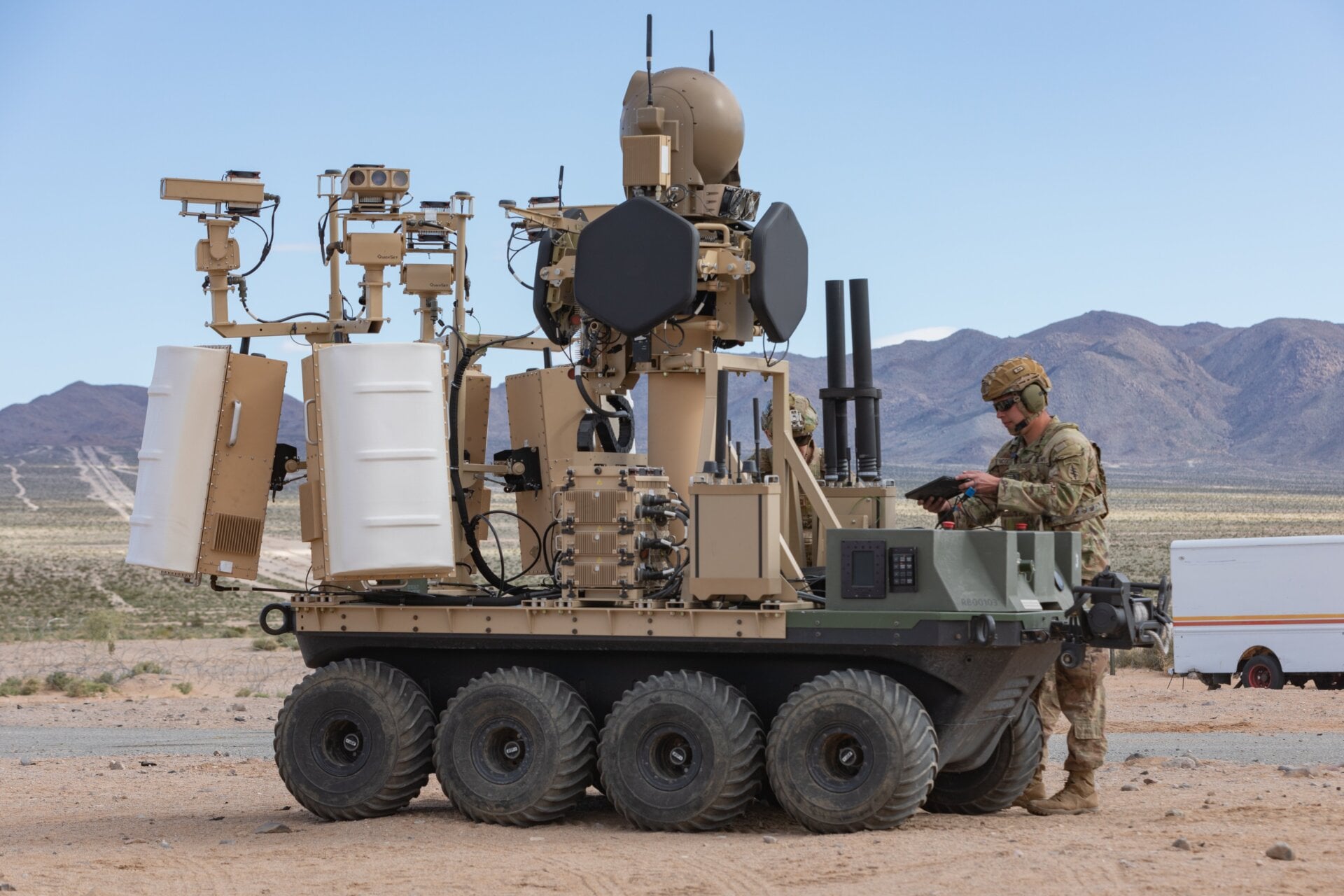 A U.S. Army unmanned, eight-wheeled, all-electric, all-terrain platform  with a modular counter-small UAS system with a human-in-the-loop  operational system under the Family of Counter Unmanned System or FoCUS  provides support to dismounted Soldiers in an urban training environment  as part of a human integration experiment at Fort Irwin, Calif., March  18, 2024. 