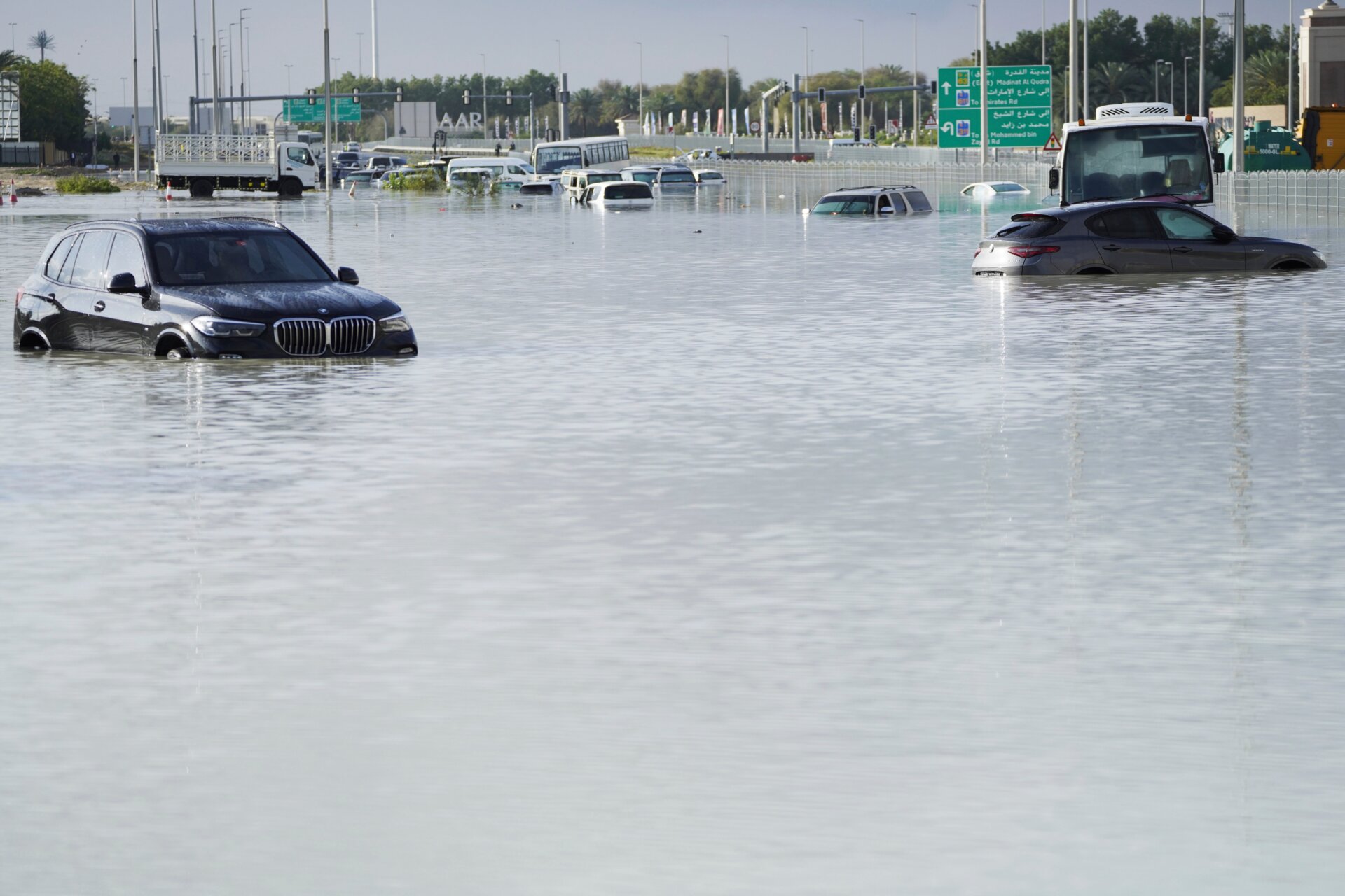 Vehicles sit abandoned in floodwater covering a major road in Dubai, United Arab Emirates, Wednesday, April 17, 2024. 