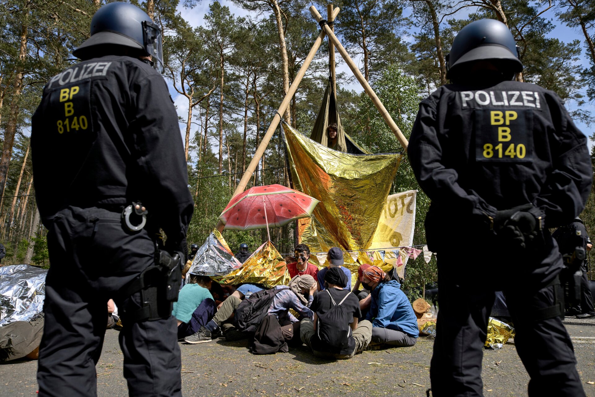 Police stand next to a road blockade by activists during a protest against Tesla on May 10, 2024.  