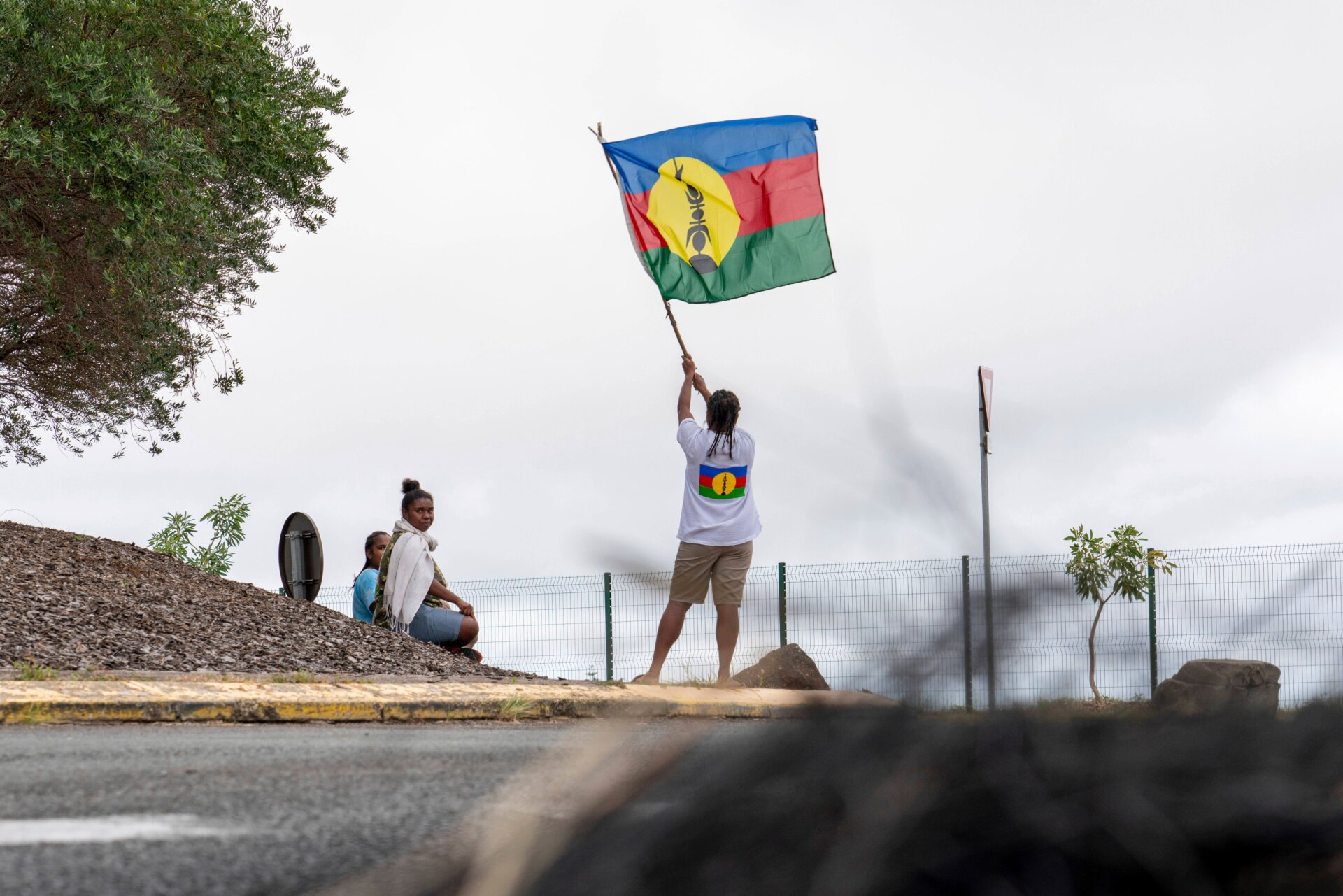 Protester holds a New Caledonia territorial flag on May 14, 2024.