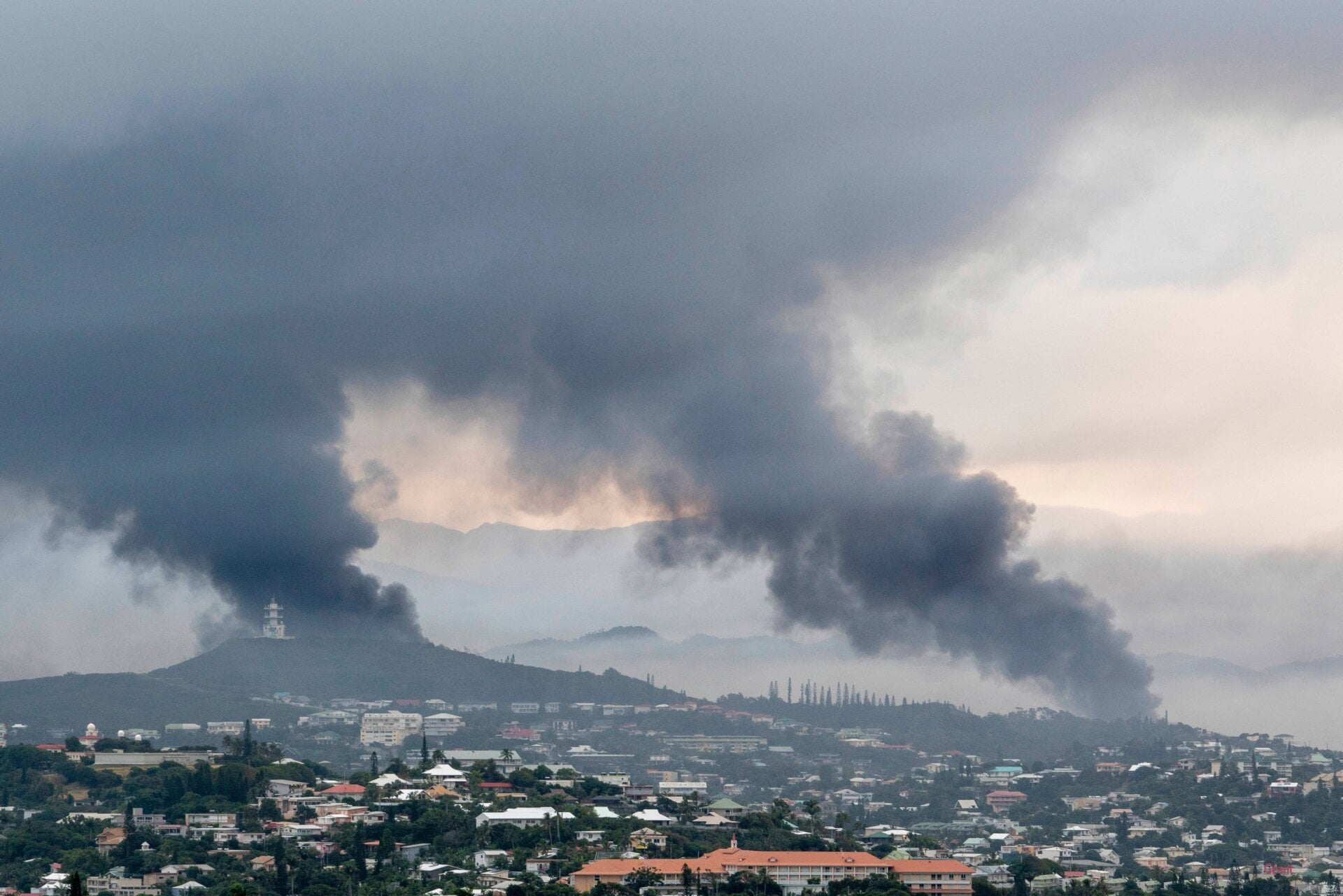 Smoke rises in the distance in Noumea, New Caledonia on May 14, 2024.