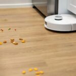 A photo of a robot vacuum working its way toward mess