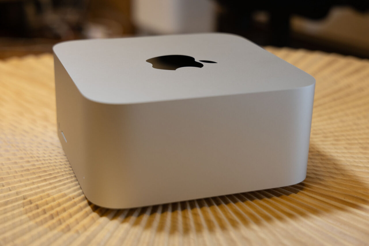 Side shot of Apple Mac Studio on wooden table