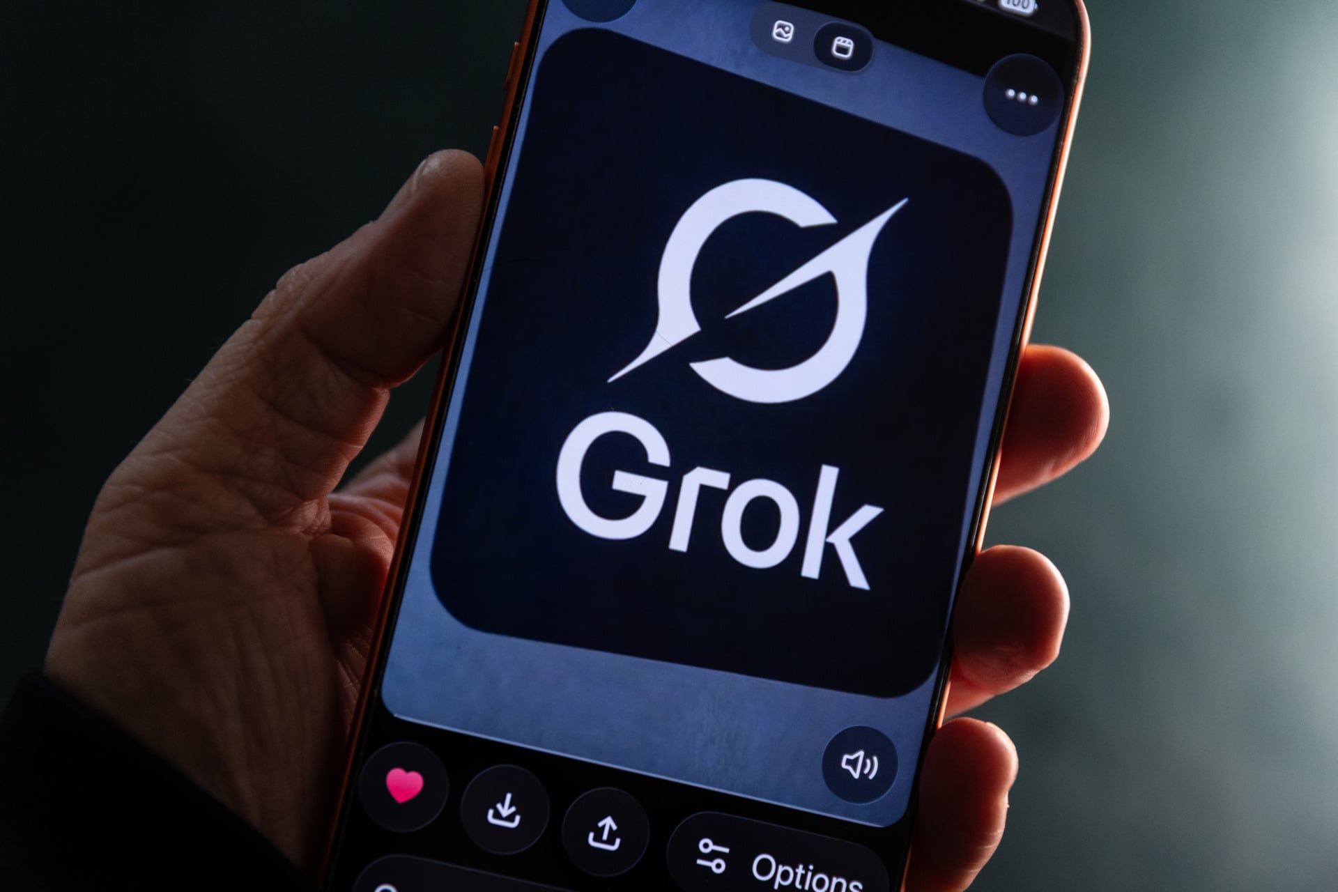 In this photo illustration a iPhone screen displays the Grok logo within the Grok AI app