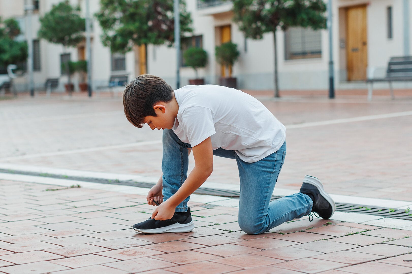 Boy tying shoelaces