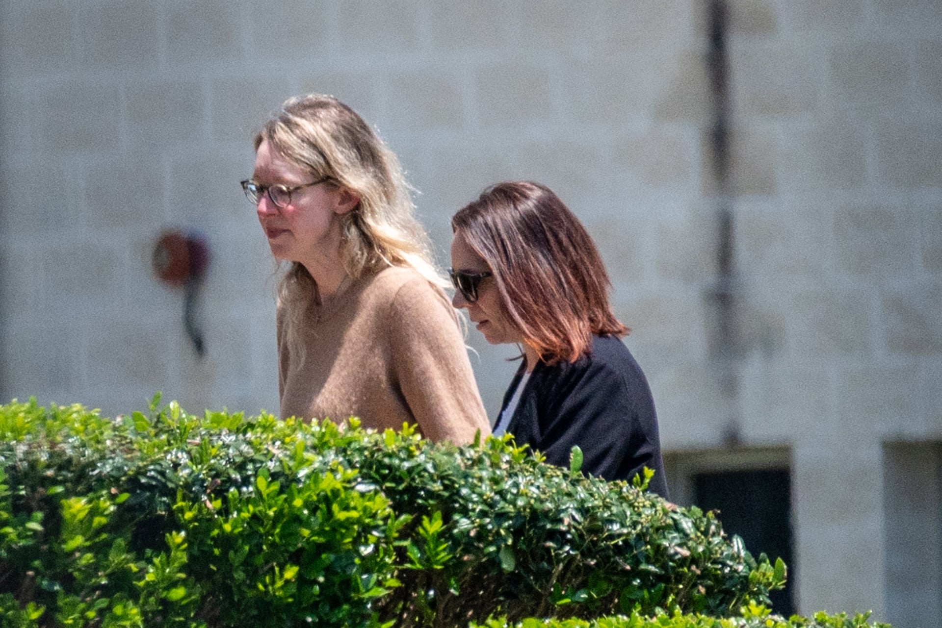 Elizabeth Holmes, founder of Theranos Inc., left, arrives at Federal Prison Camp Bryan in Bryan, Texas, US, on Tuesday, May 30, 2023. 