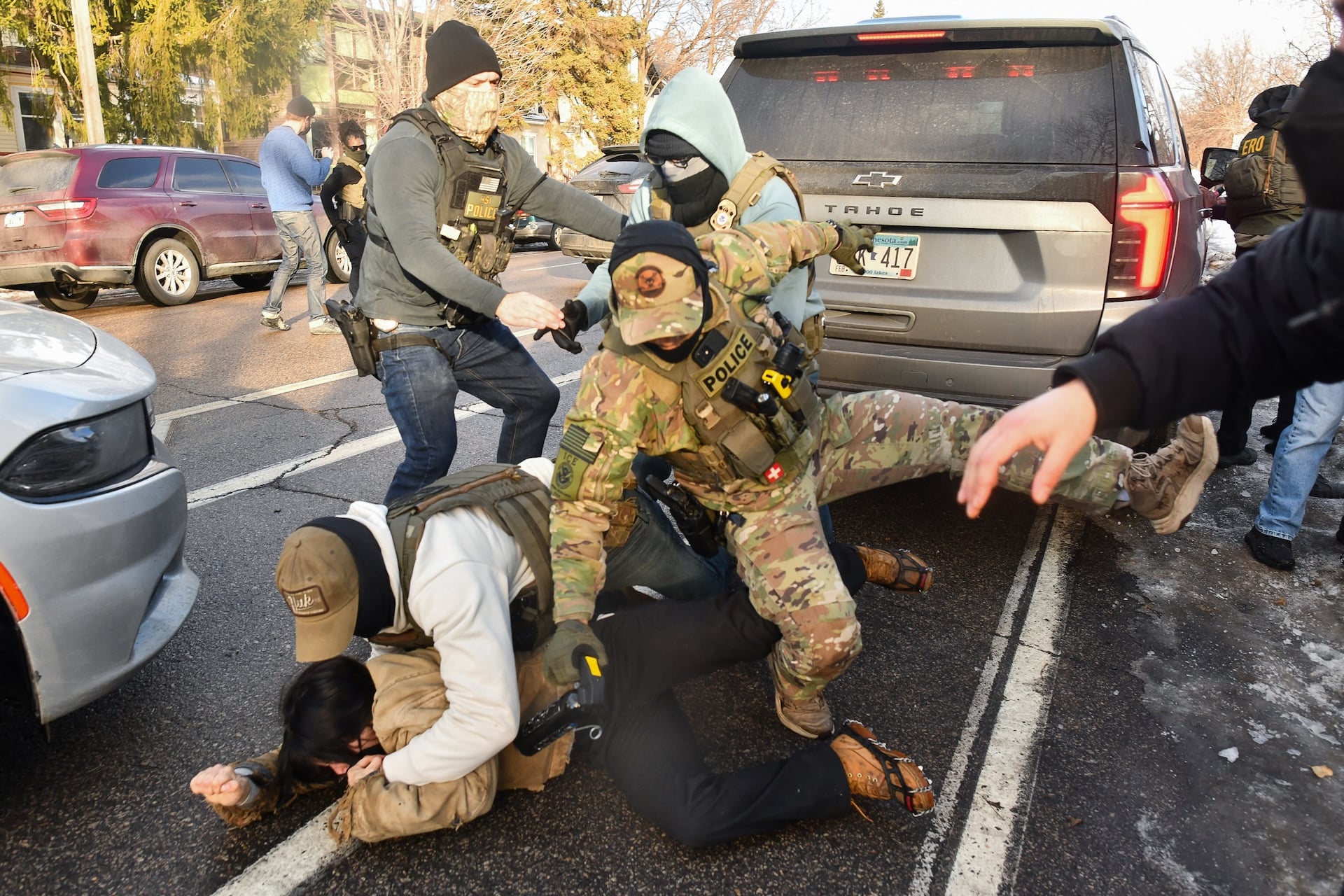 ICE and other federal officers brutalize a person in a residential neighborhood in Minneapolis, Minnesota, on January 13, 2026.