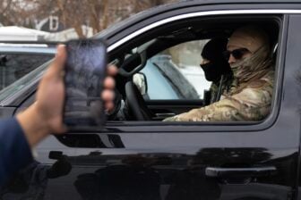 Border Patrol agents are confronted by activists after making an apprehension on January 11, 2026 in Minneapolis, Minnesota.