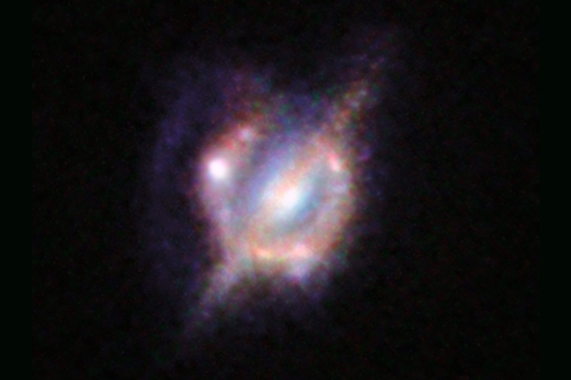 A composite image of the galaxy H-ATLAS J142935.3-002836, combining views from the Hubble Space Telescope and the Keck Observatory.