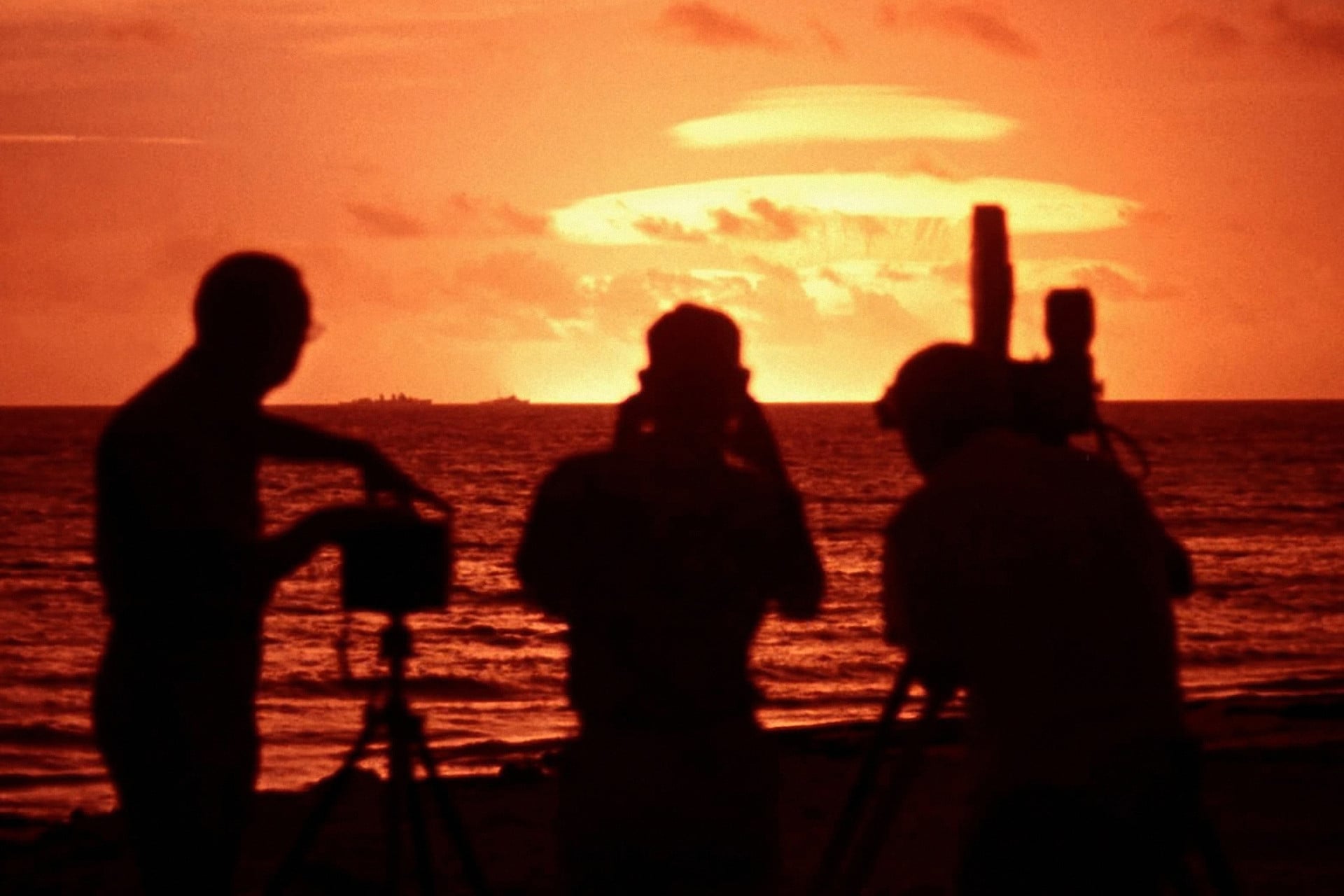 Photographers and camera crew on Eniwetak Atoll during Koa nuclear test as part of Operation Hardtack, a series of 35 nuclear tests conducted by the United States in 1958 at the Pacific Proving Grounds. 12th May 1958. 