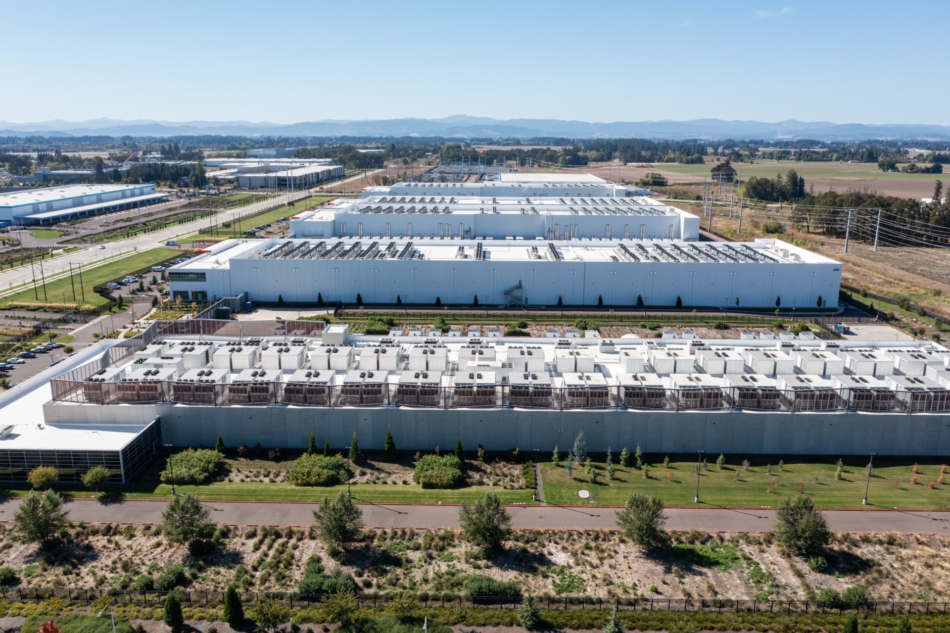 erial drone picture of QTS Hillsboro data center buildings with rooftop HVAC cooling units and surrounding industrial area infrastructure