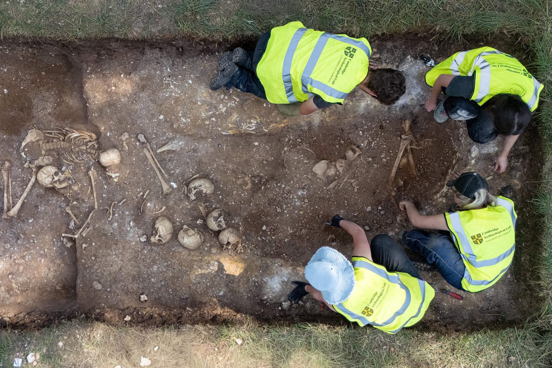 Archaeologists and students found a pit of human remains near Cambridge, England.