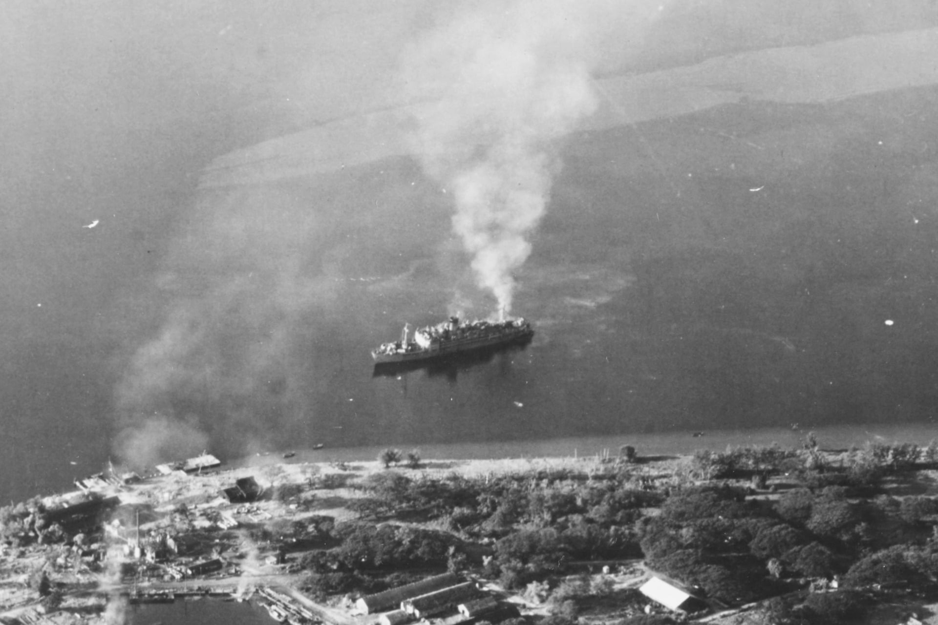Above, the Japanese prison ship the Oryoku Maru, as it continued to sink and smoulder into Subic Bay in the Philippines on December 16, 1944.