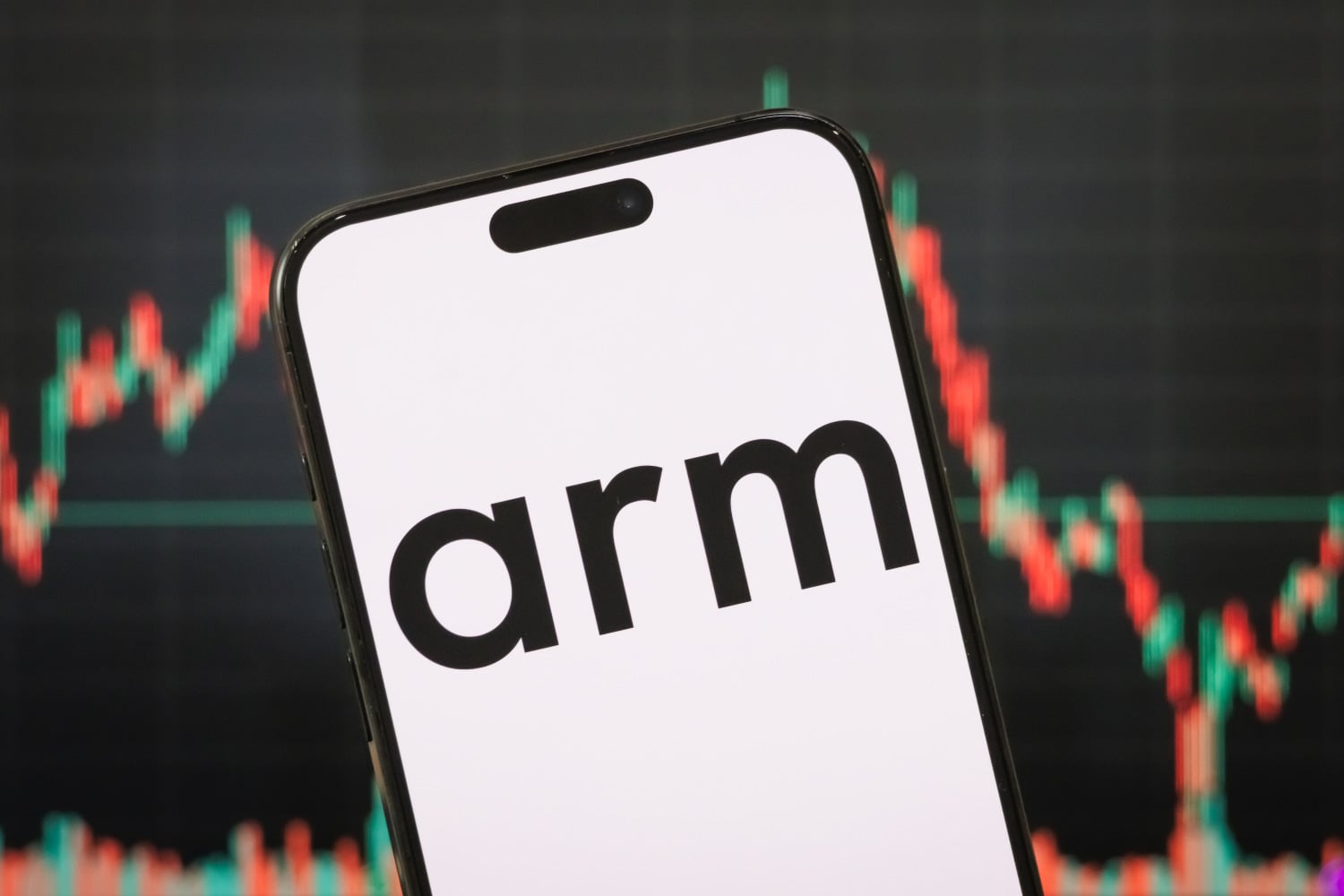 the logo of Arm Holdings plc is displayed on a smartphone screen, with a stock market chart in the background 