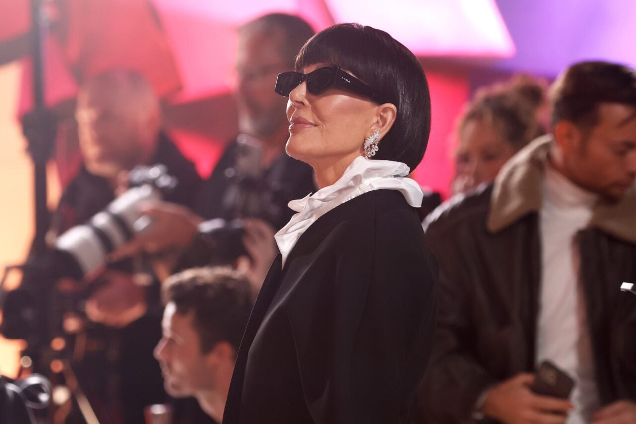 A photo of Kris Jenner wearing sunglasses and looking up.