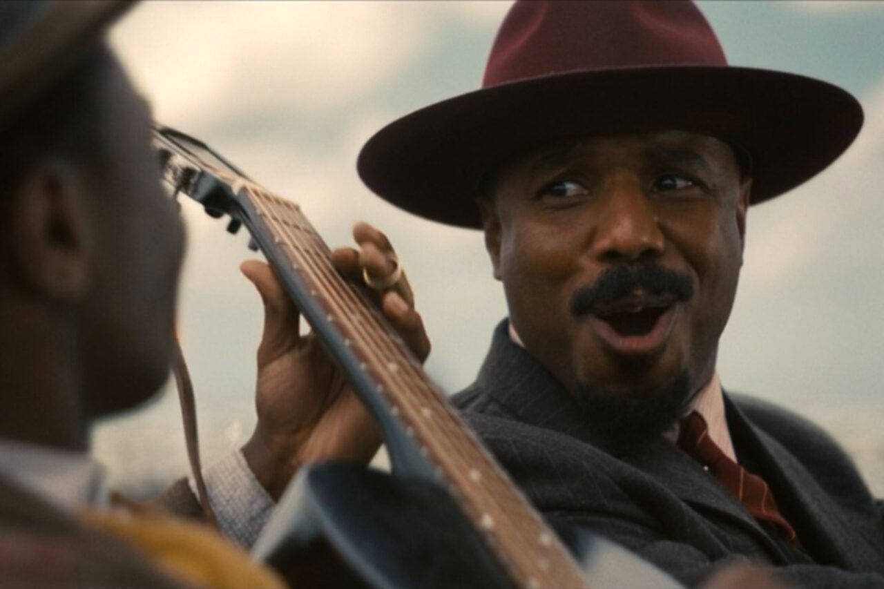 Sinners still of Michael B. Jordan's Stack smiling.