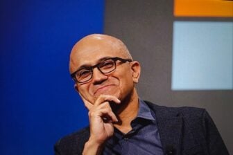 Microsoft CEO Satya Nadella smiling with his hand on his chin