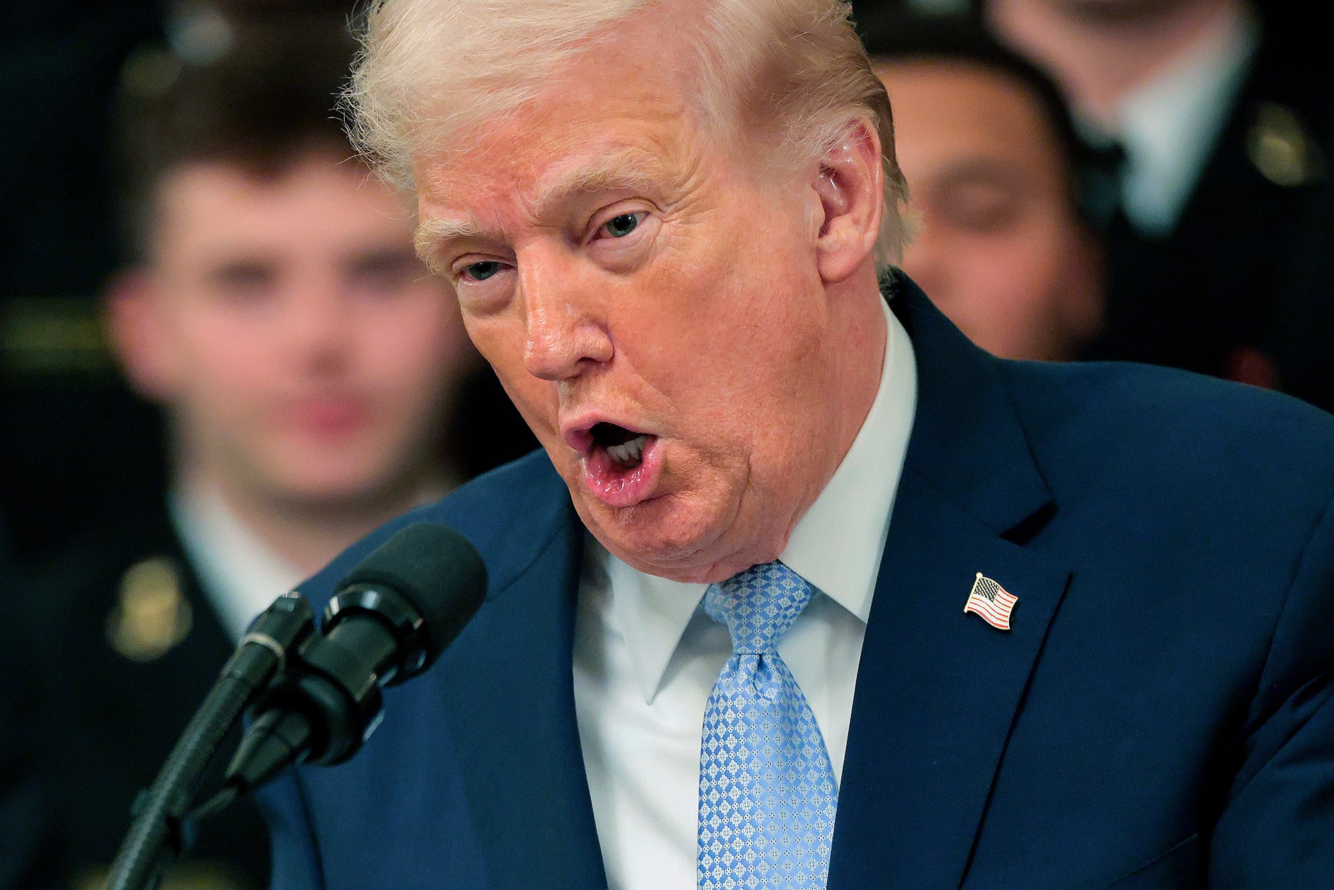 Donald Trump speaking at a podium