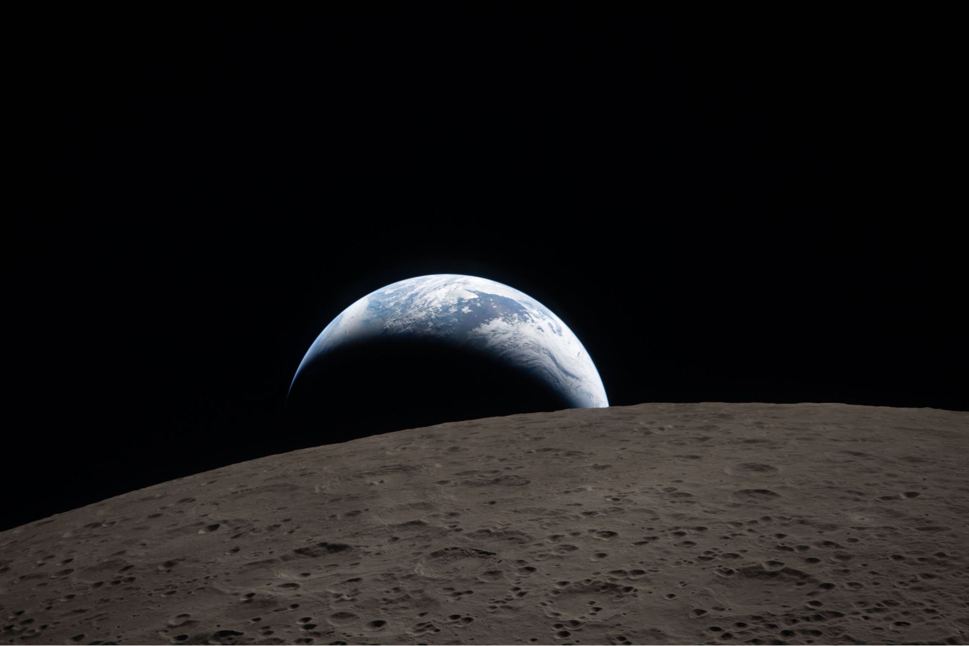 Earthset captured through the Orion spacecraft window at 6:41 p.m. ET, April 6, 2026, during the Artemis II crew’s flyby of the Moon.