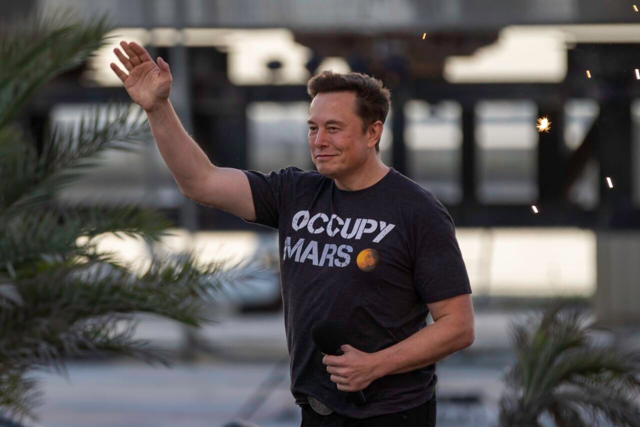 A photo of Elon Musk with an "Occupy Mars" T-shirt.