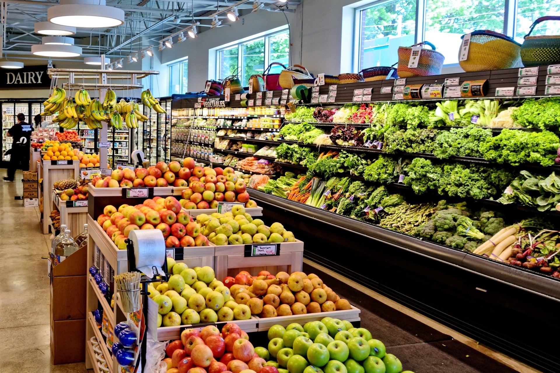 Above, a supermarket aisle replete with fresh fruits and vegetables, some regrettably contaminated with residual pesticides and herbicides.
