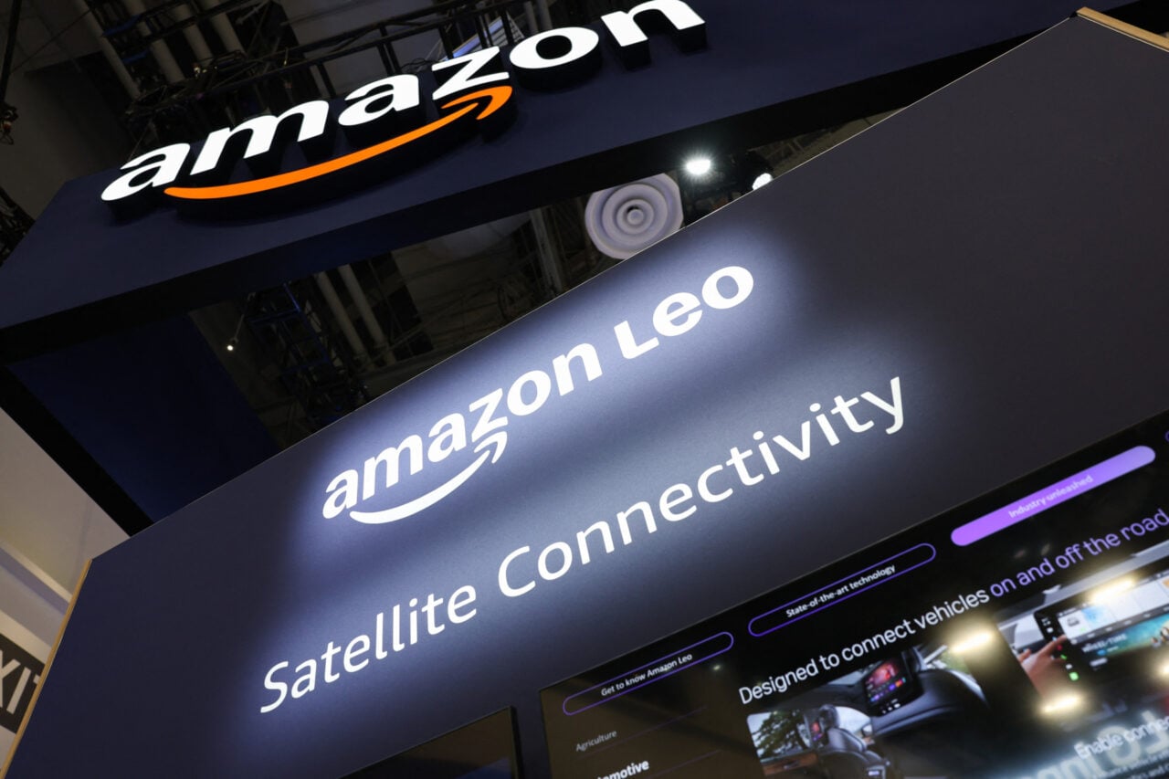 A lit up sign reads "Amazon Leo" and under it "Satellite Connectivity."