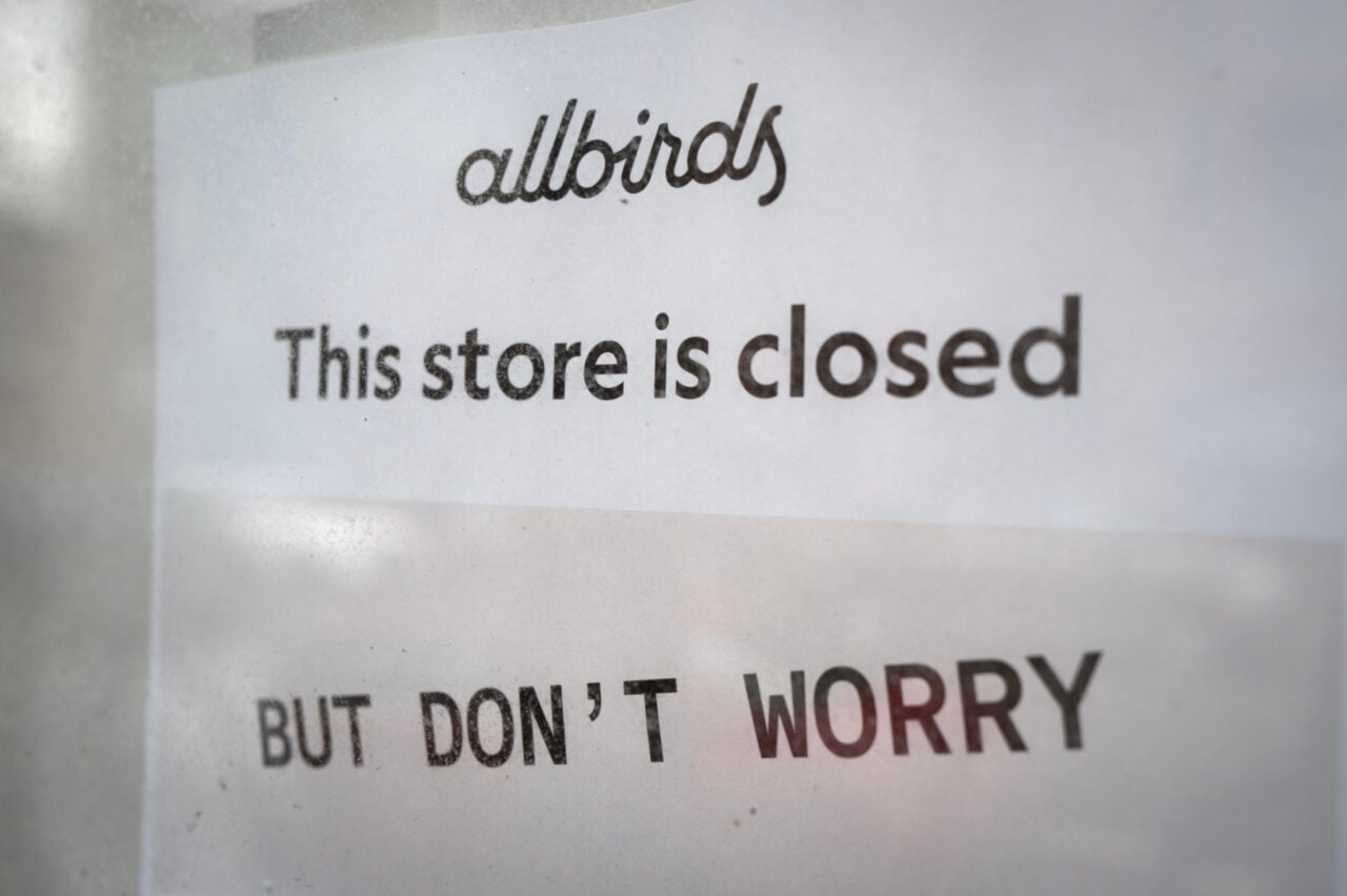 An Allbirds storefront with a sign that says "this store is closed"