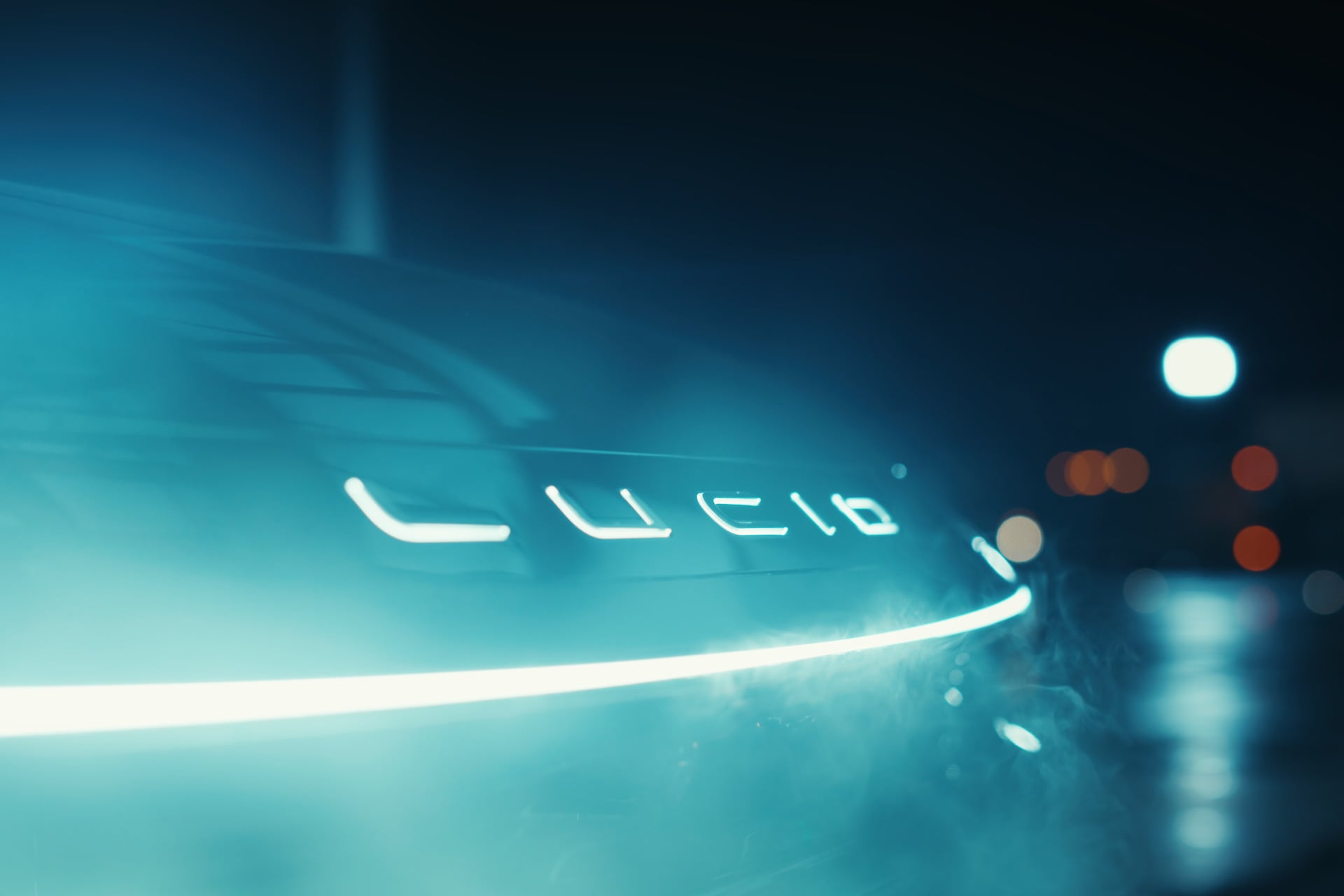 The front logo of a Lucid vehicle lit up.