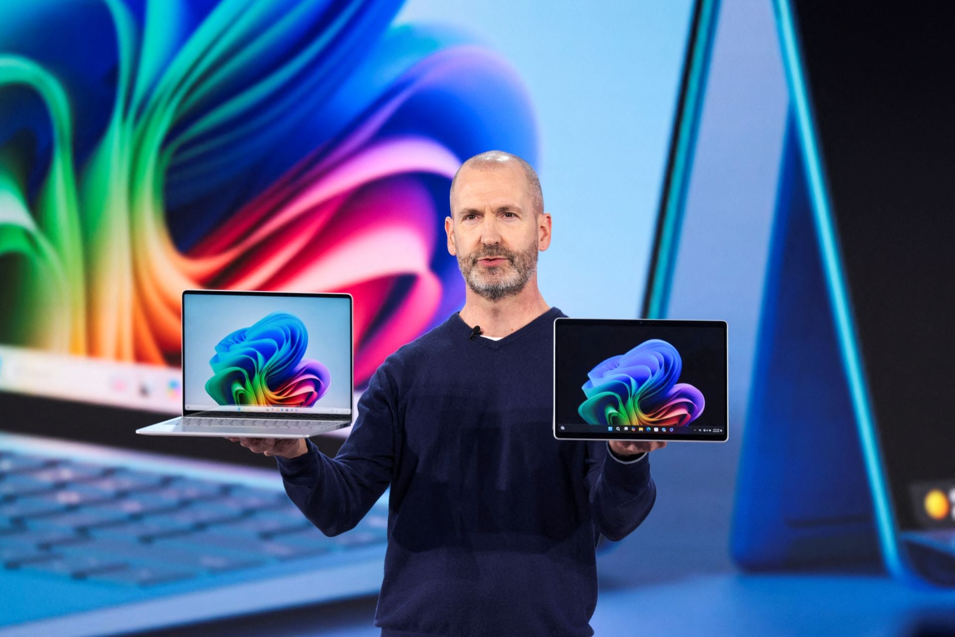 Microsoft Surface Pcs Brett Ostrum holding two Surface PCs