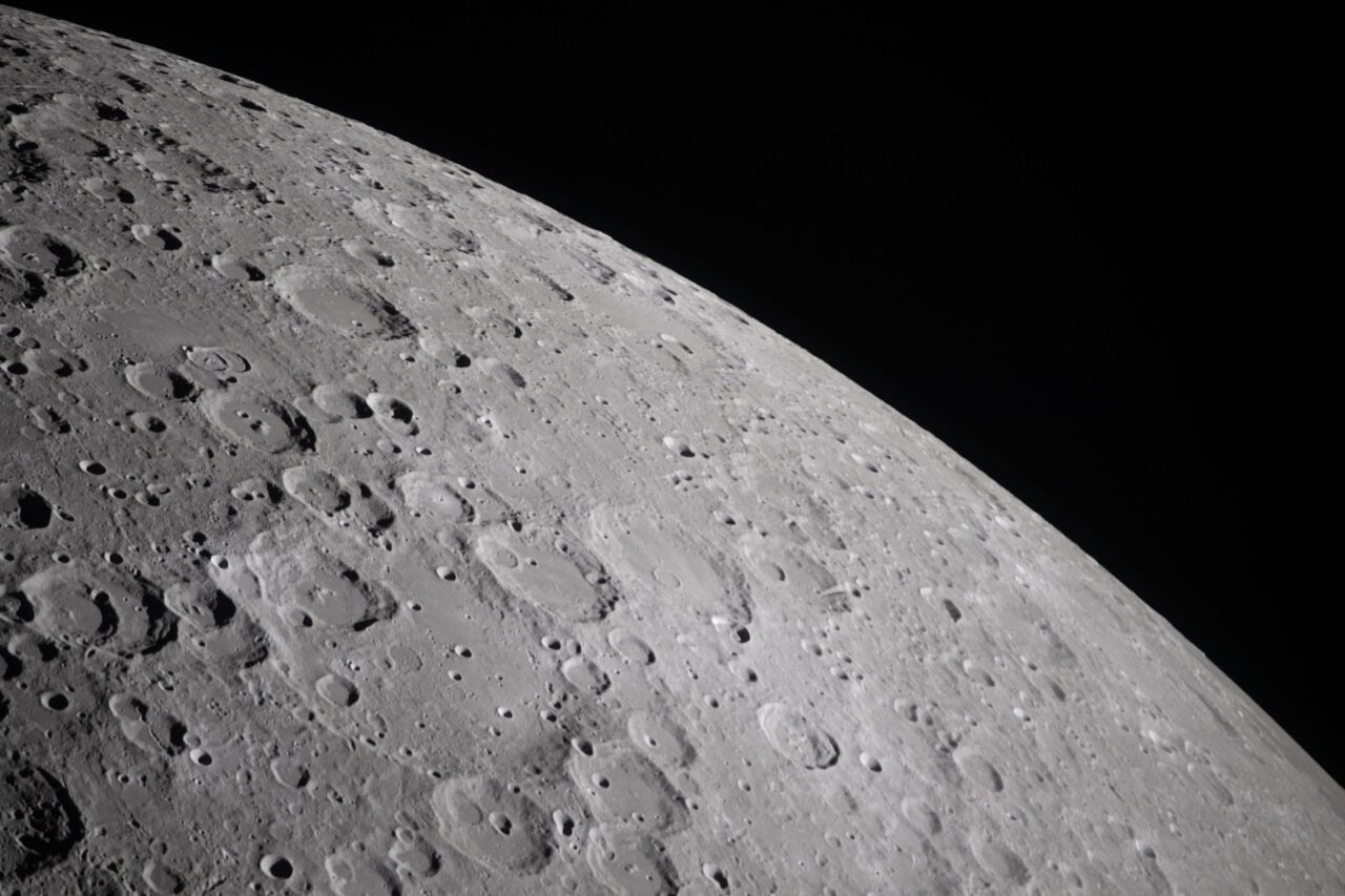 During its lunar flyby, the Artemis 2 crew captured cratered terrain, revealing the Moon’s rugged, collision-scarred surface.