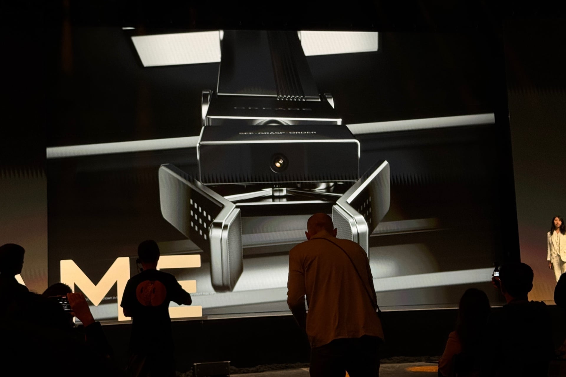 Render of the inside of the fridge, pointed up at the robot arm as it descends.