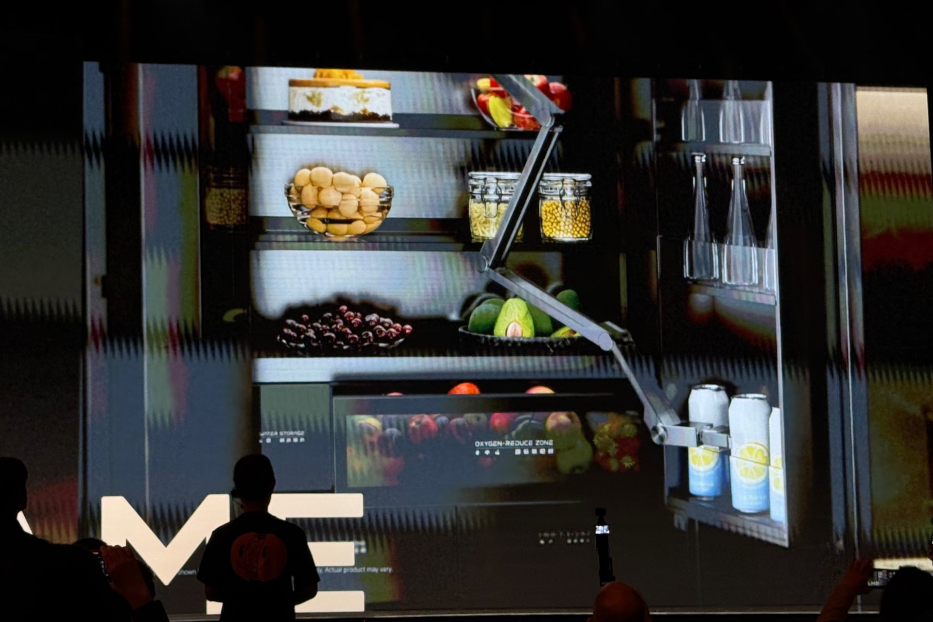 A robot arm in a refrigerator, grabbing a beverage can.