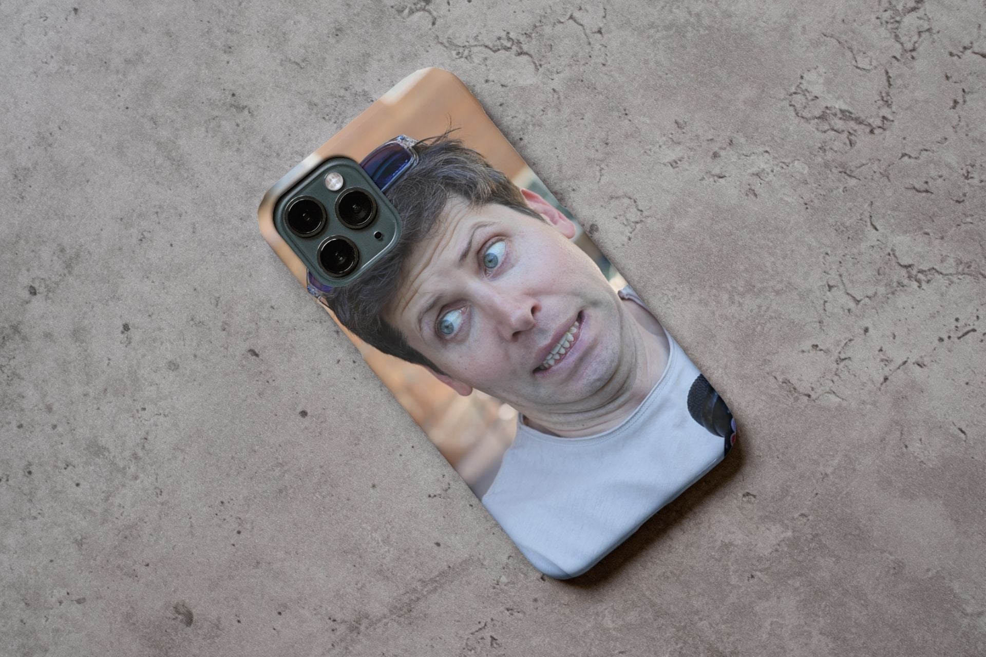 A mockup of Sam Altman's face on the back of a phone.
