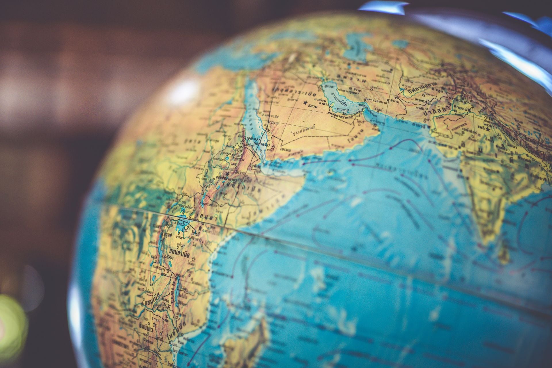 A world globe showing latitude and longitude lines across Earth.