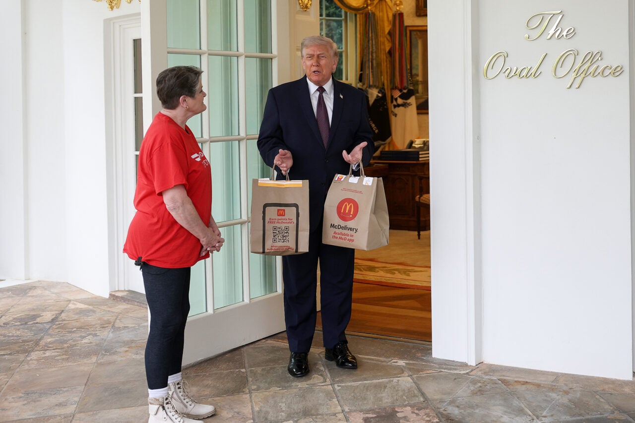 U.S. President Donald Trump receives a DoorDash delivery of McDonald's from Sharon Simmons before he speaks to the press during an event outside the Oval Office of the White House on April 13, 2026 in Washington, DC. The president spoke about the No Tax on Tips, Pope Leo XIV and the ongoing negotiations with Iran.