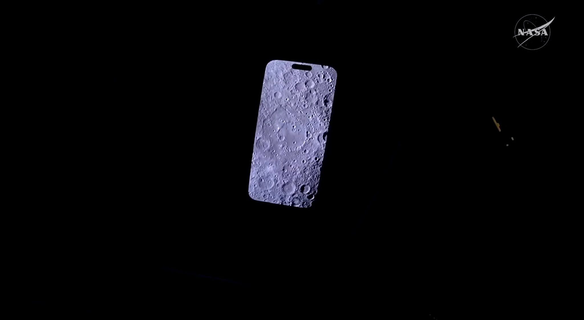 Craters on the moon seen on the display of an iPhone against a dark background