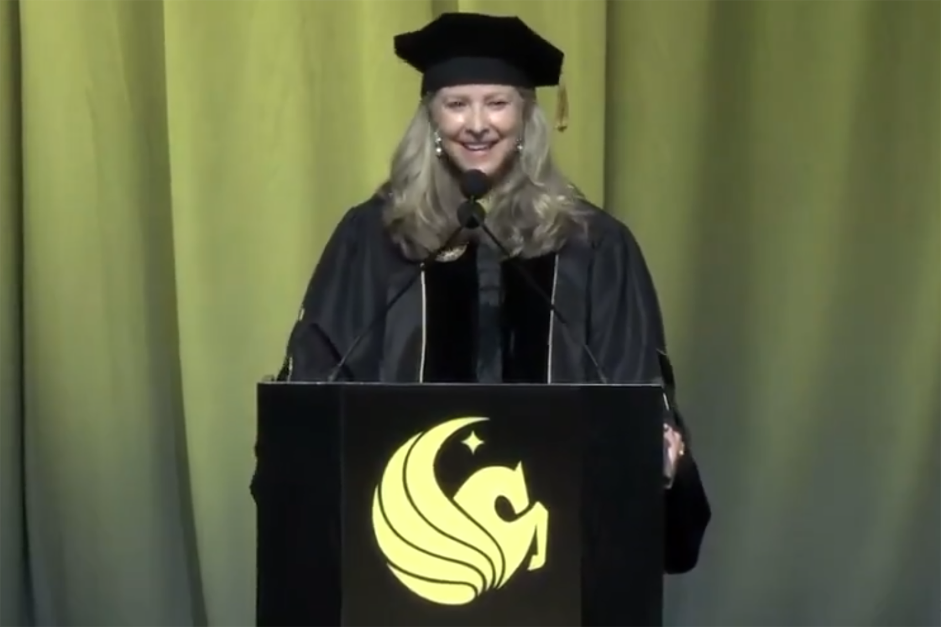 Gloria Caulfield seen giving the commencement speech at the University of Central Florida.