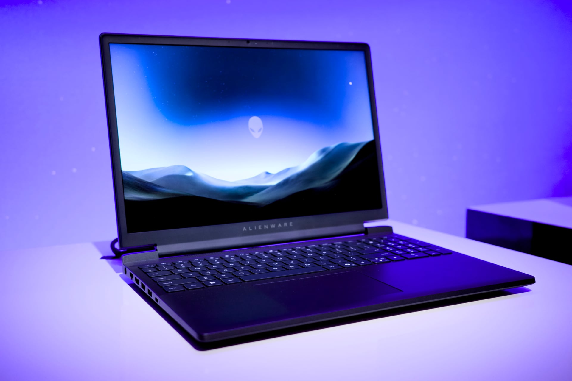 Dell Alienware 15 Gaming Laptop on a desk with a default screensaver